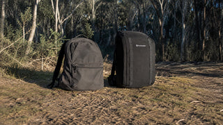 An ordinary backpack sagging beside a structured rucking backpack on an Australian bush trail