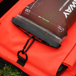 Close-up of a red life jacket with a digital display on a grassy background