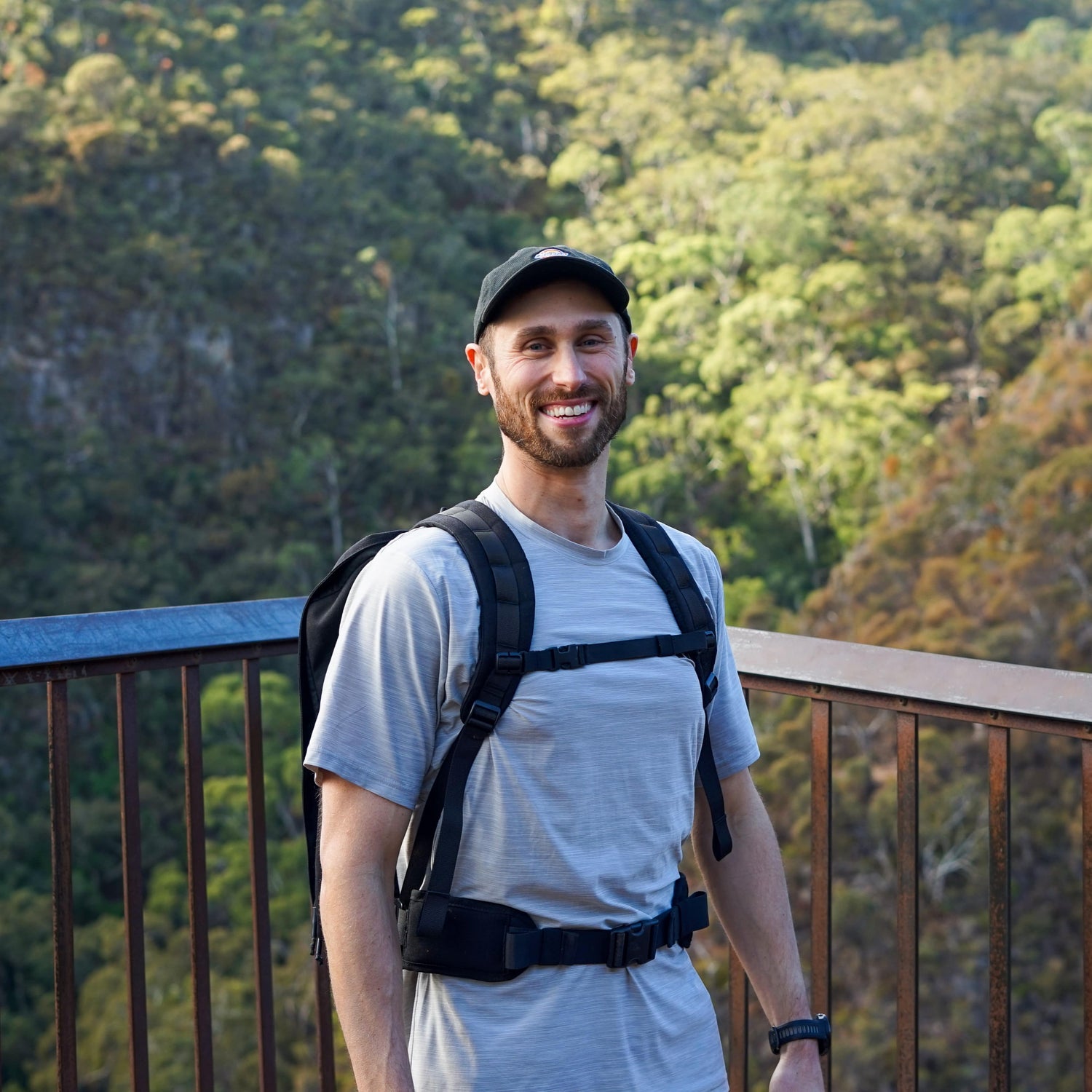 Man smiling whilst wearing Ruckaway rucking backpack